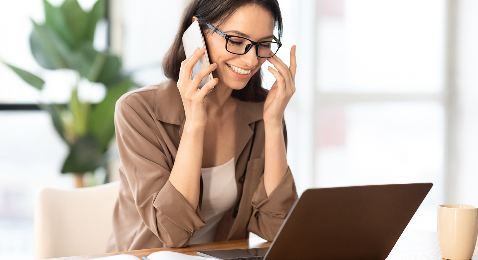 Excited girl talking on the phone at office